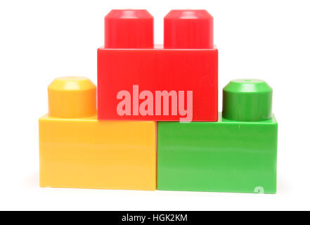 Colorful stacked toy plastic building blocks isolated on white background Stock Photo