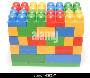 Colorful stacked toy plastic building blocks isolated on white background Stock Photo