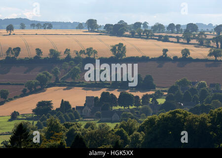 Cotswold farmland and St Michael's and All Angels church, Guiting Power, Cotswolds, Gloucestershire, England, United Kingdom Stock Photo