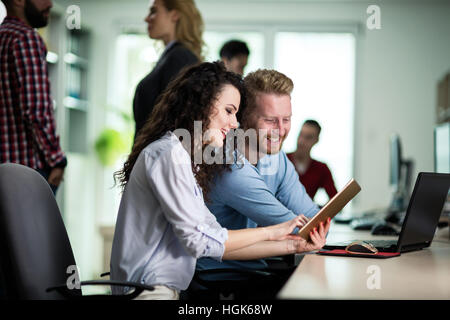 Programmers cooperating at  IT company developing apps Stock Photo