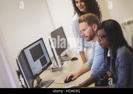 Programmers and business people collaborating in company office Stock Photo