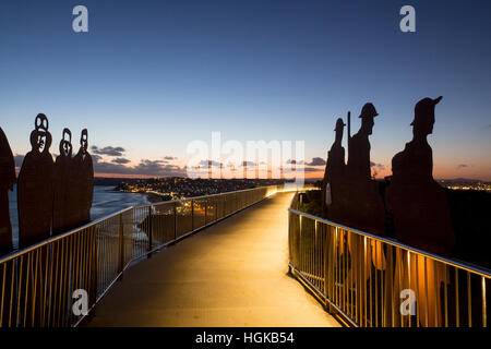 Anzac Memorial Walk figures at dusk overlooking Bar Beach and coastline Newcastle NSW Australia Stock Photo