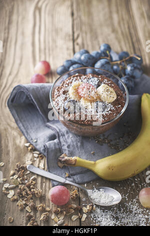 Chocolate chia pudding with fruit in the glass bowl vertical Stock Photo