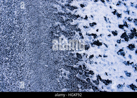Ice pattern made by a hoar frost on a tarmac road.  Scottish borders. Scotland Stock Photo
