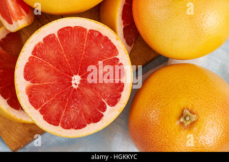 Fresh red grapefruit on wooden cutting board. Top view Stock Photo