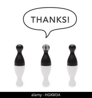 Black pawns say "thanks" with text balloon in black and white Stock Photo