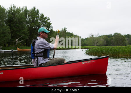 A man canoeing in Kejimkujik National Park and National Historic Site in Nova Scotia, Canada. Stock Photo