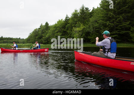 Men canoeing in Kejimkujik National Park and National Historic Site in Nova Scotia, Canada. Stock Photo