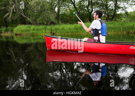 A man canoeing in Kejimkujik National Park and National Historic Site in Nova Scotia, Canada. Stock Photo