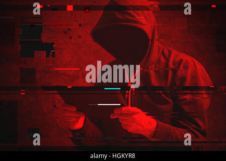 Cyber attack with unrecognizable hooded hacker using tablet computer, digital glitch effect Stock Photo