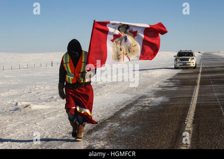 Breien, North Dakota, USA. 10th Jan, 2017. DEMI YELLOW LODGE-BLACK BEAR of the Oglala Lakota Nation walks along Highway 6 as she enters the Standing Rock Indian Reservation near Breien, North Dakota. The Youth Unity Journey for Sacred Waters, led by members of the Woodland Cree First Nations in Saskatchewan, Canada, completed their 46-day-long journey after walking 870 miles from Stanley Mission, Canada to the Oceti Oyate Camp bordering the Standing Rock Indian Reservation near Cannon Ball, North Dakota. © Joel Angel Juarez/ZUMA Wire/Alamy Live News Stock Photo