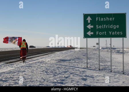 Breien, North Dakota, USA. 10th Jan, 2017. DEMI YELLOW LODGE-BLACK BEAR of the Oglala Lakota Nation walks along Highway 6 as she enters the Standing Rock Indian Reservation near Breien, North Dakota. The Youth Unity Journey for Sacred Waters, led by members of the Woodland Cree First Nations in Saskatchewan, Canada, completed their 46-day-long journey after walking 870 miles from Stanley Mission, Canada to the Oceti Oyate Camp bordering the Standing Rock Indian Reservation near Cannon Ball, North Dakota. © Joel Angel Juarez/ZUMA Wire/Alamy Live News Stock Photo