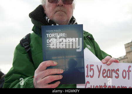 London UK. 11th January 2017. A protester holds a book which reads' Does Tourture Work' during a protest  against the US military camp in Guantanamo which turns 15 since it was opened in 11 January 2002 Credit: amer ghazzal/Alamy Live News Stock Photo