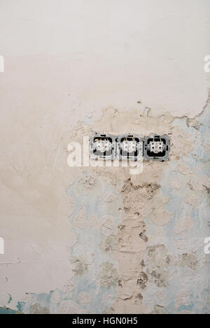 Damaged plug of abandoned building. Stock Photo