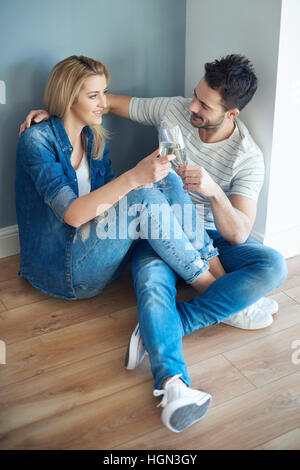 Joyful couple taking break from unpacking Stock Photo