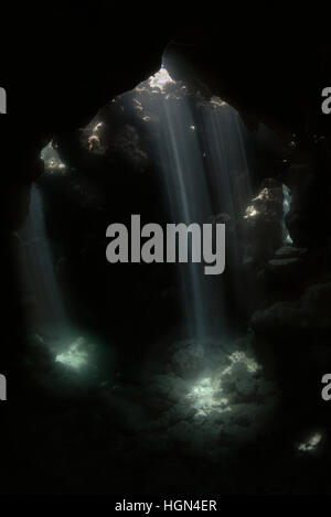 Lights and darks, sun rays or Chiaroscuro in the stony caves and caverns of the Red Sea reefs near the shores of Egypt. Stock Photo