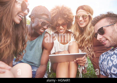 Friends looking at tablet and checking news Stock Photo