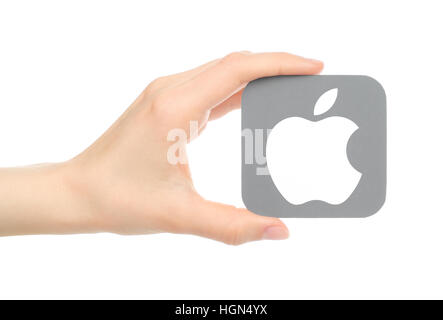 Kiev, Ukraine - May 18, 2016: Hand holds popular operating system logo printed on paper Apple ios. Apple Inc. is an American multinational technology  Stock Photo