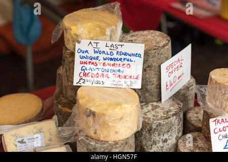 Cheese for sale on a market stall including unpasturised Glastonbury Cheddar Stock Photo