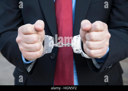 Businessman in handcuffs Stock Photo