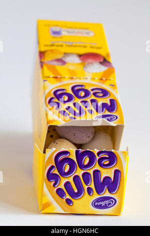 Carton of Cadbury mini eggs undone to show contents ready for Easter set on white background Stock Photo