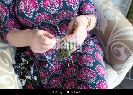 Knitting - close up of a lady's hands knitting Stock Photo