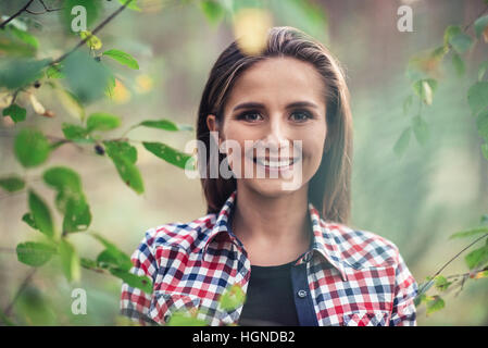 Young woman smiling in nature Stock Photo