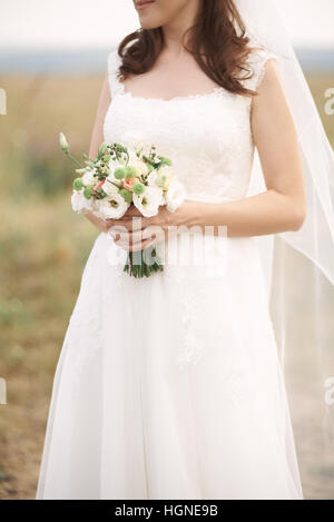 Bridal bouquet. Beautiful bouquet of different colors in the hands of the bride Stock Photo