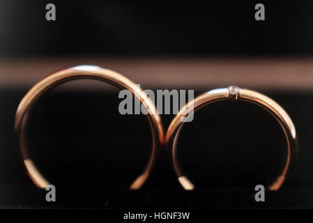 Wedding rings on black background. Macro shot Stock Photo