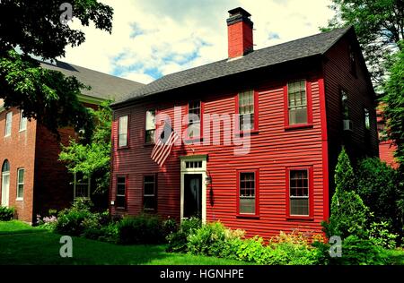 Hancock, New Hampshire:18th century wooden colonial home flying American flag and 1836 Congregational Church Vestry House Stock Photo