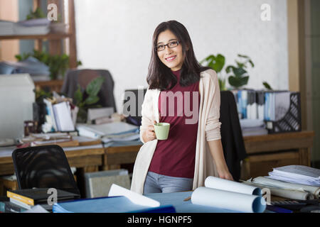 Female architect relaxing in the office Stock Photo