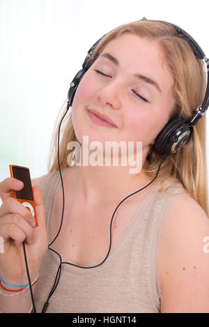 TEEN LISTENING TO MUSIC Stock Photo