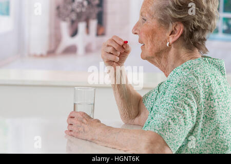 SENIOR TAKING MEDICATION Stock Photo