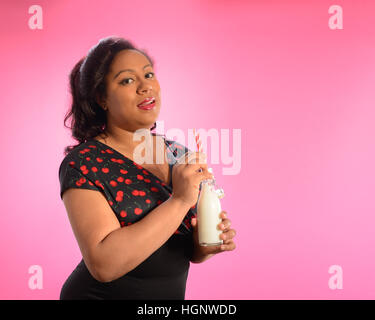 Pin up girl drinking milk from retro bottle Stock Photo