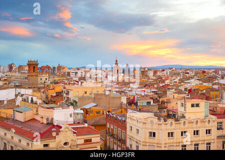 Old Town of Valencia at sunset. Plane flying in the sky. Spain Stock Photo