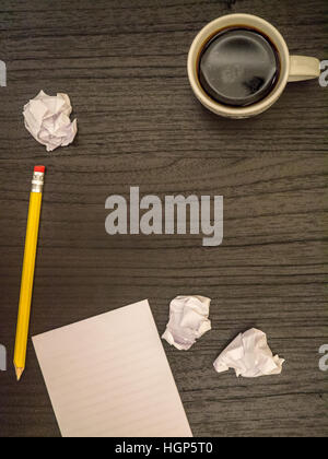 Dark surface, paper wads, pencil, coffee black Stock Photo