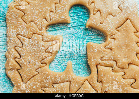 metal molds on dough men tree a blue wooden background Stock Photo