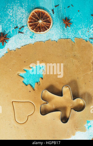 metal molds on dough men tree a blue wooden background Stock Photo
