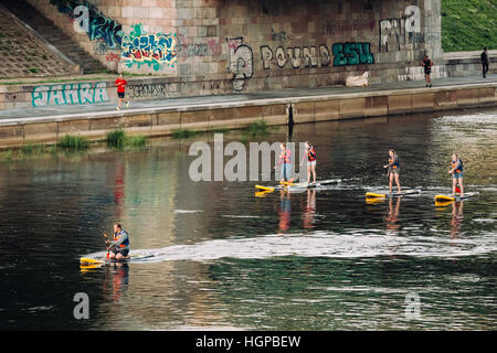 Vilnius, Lithuania - July 08, 2016: Three Young People Stand Up Paddling SUP Or Standup Paddle Boarding On Neris River Stock Photo