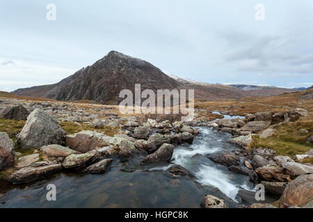 A mountain stream exits Llyn Idwal and heads towards the base of Pen Yr Ole Wen in the Ogwen valley, Snowdonia Stock Photo