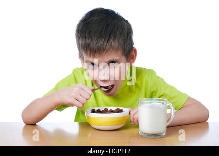 Little boy eating breakfast isolated white Stock Photo