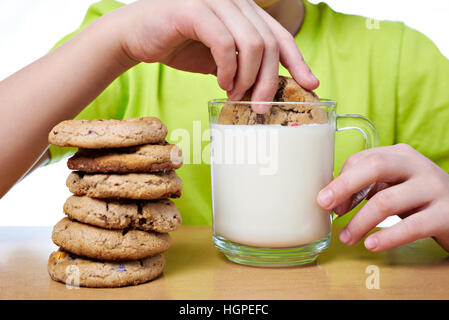 Child has breakfast cookies and milk Stock Photo