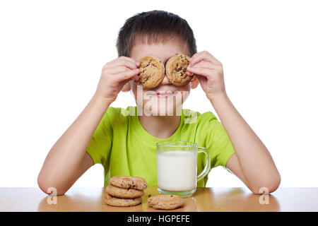 Little boy has breakfast cookies and milk isolated white Stock Photo