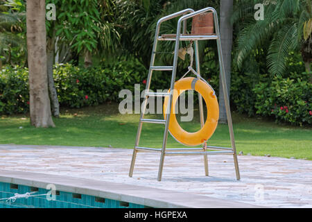 Lifebuoy on a lifeguard tower next to pool in a hotel courtyard Stock Photo