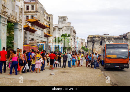 People standing in a queue to get on a bus in Havana, Cuba Stock Photo