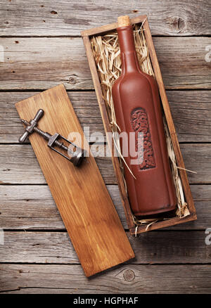 Wine bottle in box on wooden table. Top view Stock Photo