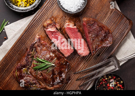 Grilled ribeye beef steak, herbs and spices. Top view Stock Photo