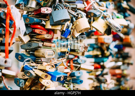 Lots of love locks on bridge in European town symbolize love forever. Stock Photo