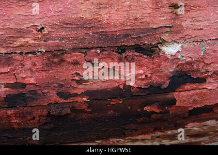 Skewed Maroon Painted Wooden Panels chipped with weather and age Stock Photo