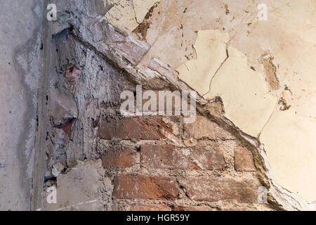 Old wall with a brick layer showing through Stock Photo